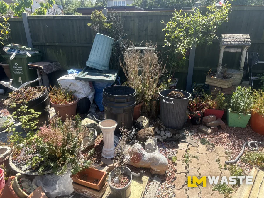 A garden full of pots, planters and ornaments before we cleared it